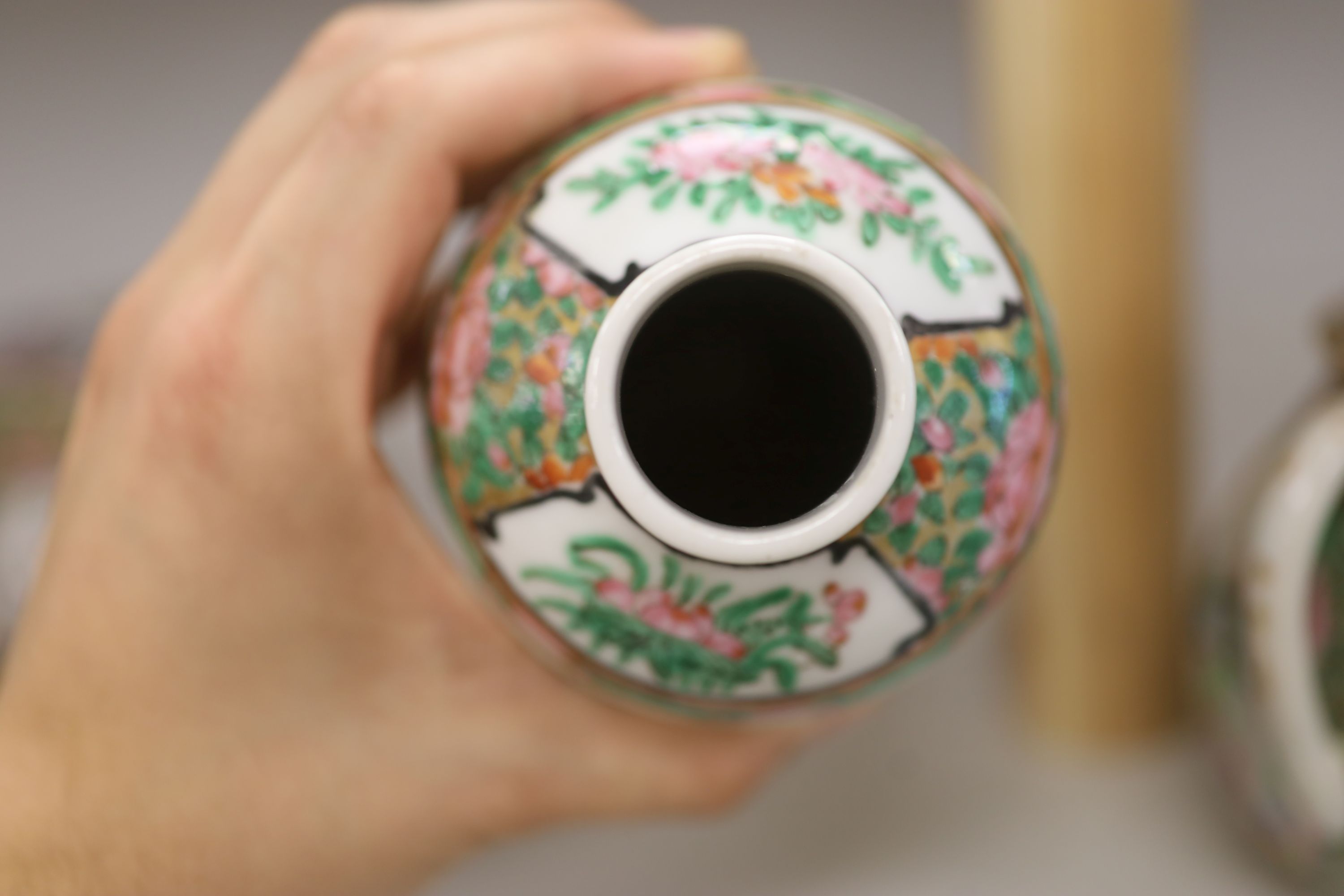 A Chinese famille rose box and cover, two vases, a sugar bowl and cover and a saucer, late 19th/early 20th century, tallest 19cm